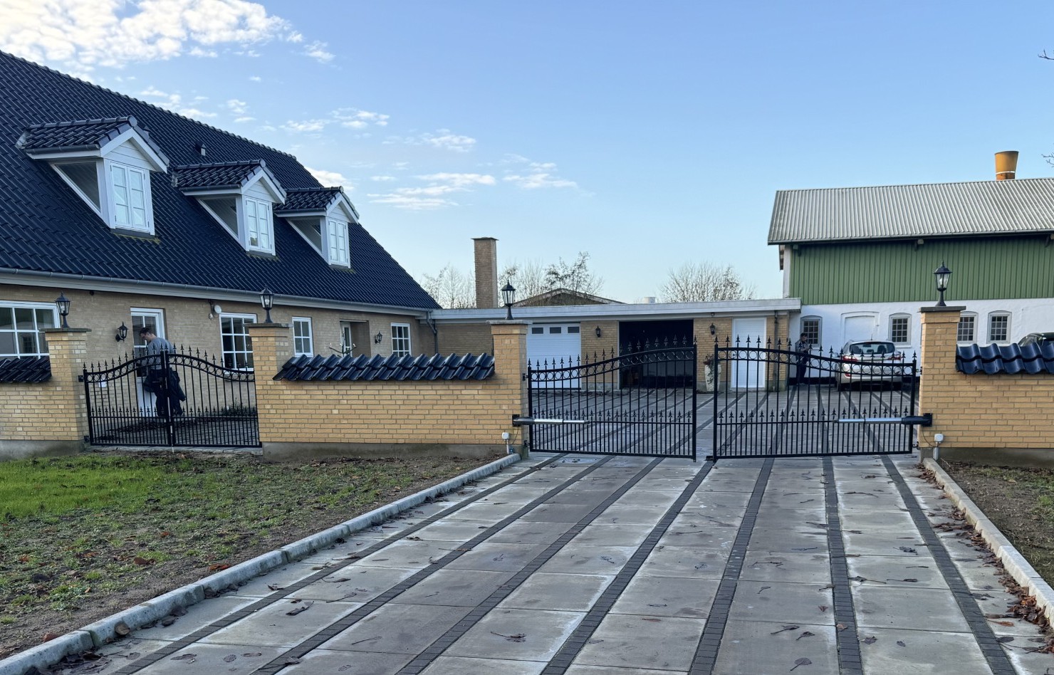 Portautomatik åbner i indkørsel og smedejernslågen til venstre bruges som gangport.